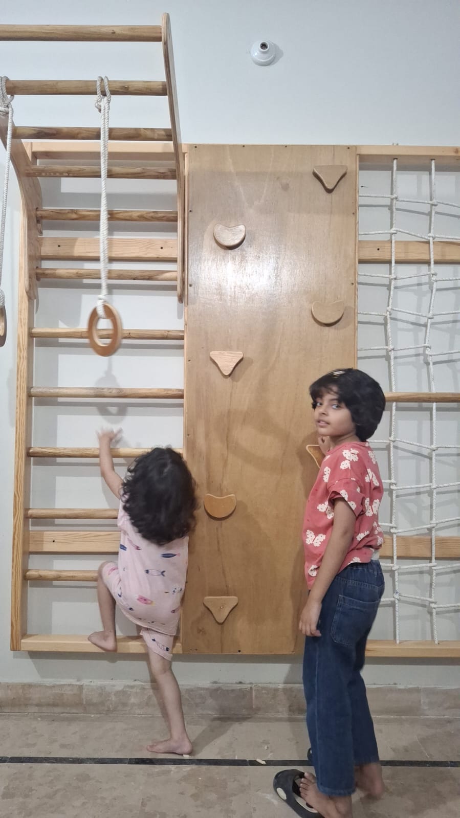 Customer photo of children using a Playfull wall-mounted wooden jungle gym