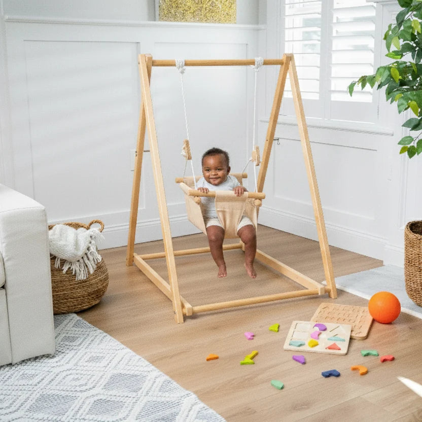 Baby seated in a compact freestanding wooden indoor swing